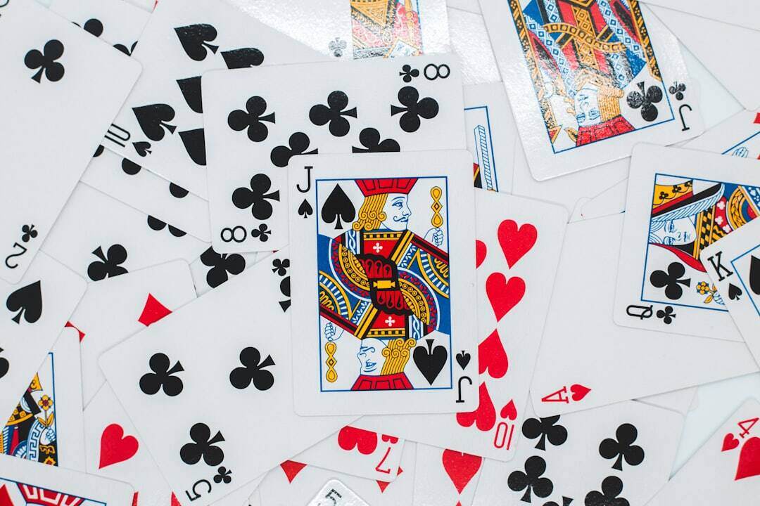 deck of cards all spread out with the jack of spades on top and in the middle