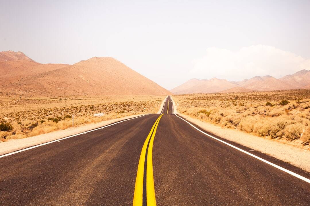 desert highway going into the distance with yellow high way lines