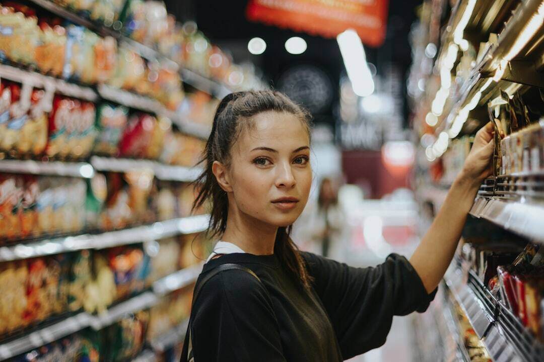 Girl in black shirt facing camera in grocery store