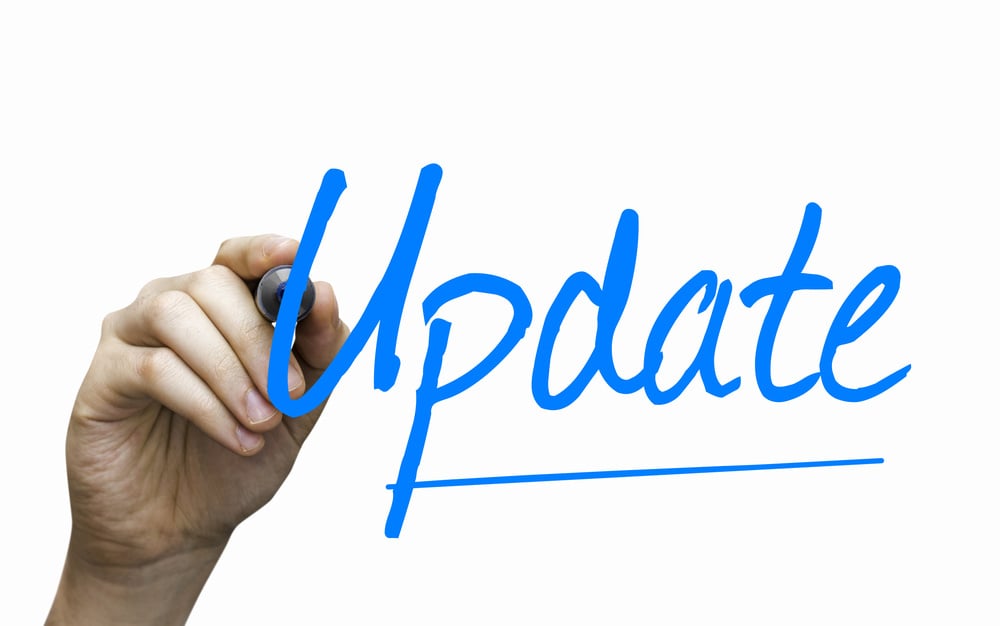 hand writing on glass with blue marker the word update