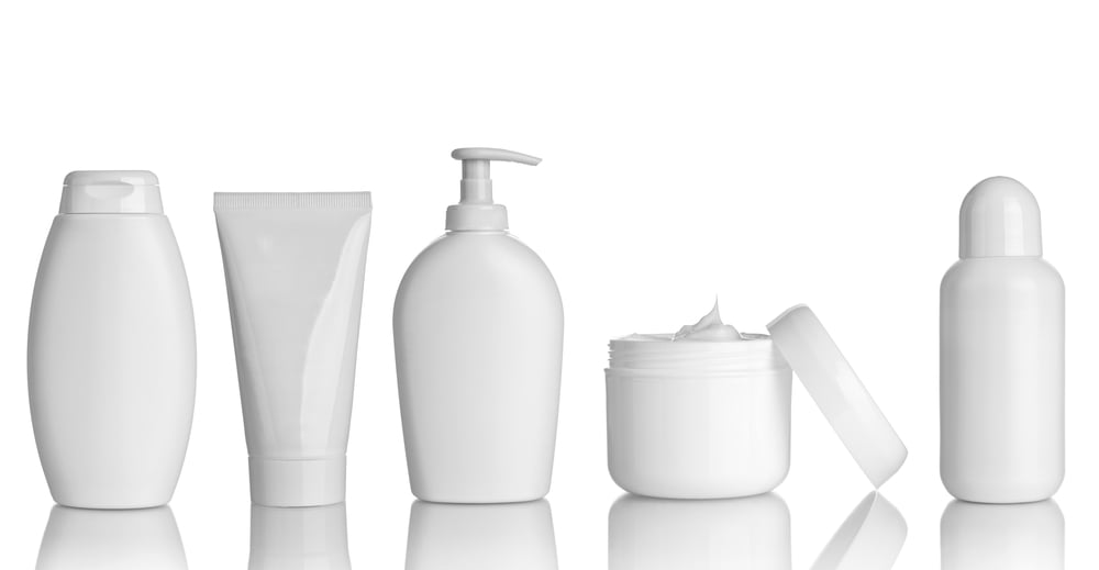 White bottles, tubes and jars with a white background